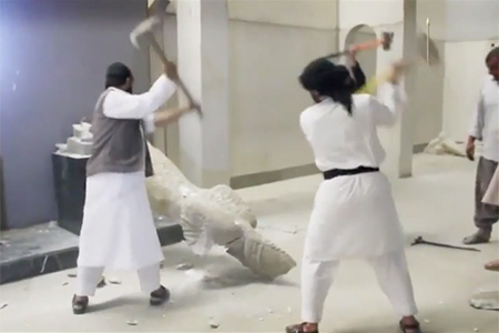 Photo of ISIS militants destroying statues in Mosul