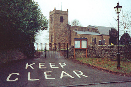 photo of a church with a big keep clear sign outside